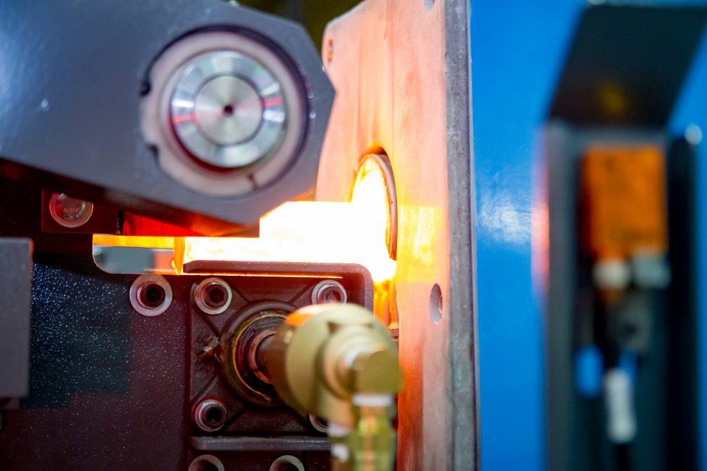 Steel billet being heated by an induction forge heating technology by Inductoheat.