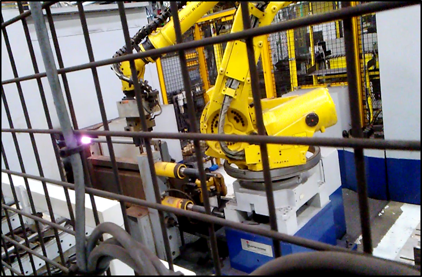 robot moving steel to an induction heating coil